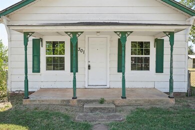 Doorway to property featuring covered porch