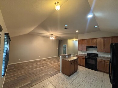 Kitchen featuring light hardwood / wood-style flooring, black appliances, lofted ceiling, and ceiling fan