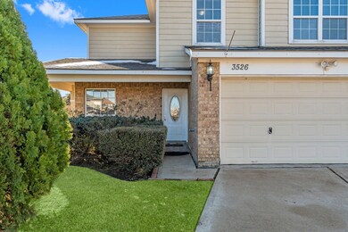 Inviting entryway of a well-maintained brick home
