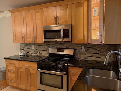 Kitchen with stainless steel appliances and Tile Back Splash