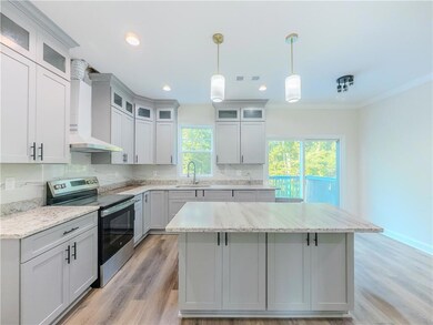 Kitchen featuring stainless steel range with electric cooktop, wall chimney exhaust hood, a center island, decorative backsplash, and hanging light fixtures