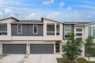 View of front of house with stucco siding, concre