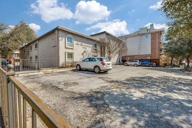 Uncovered parking lot featuring fence