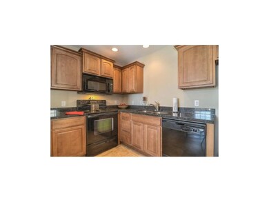 Nice granite kitchen with black appliances.