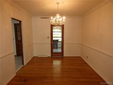 Spare room featuring an inviting chandelier, dark