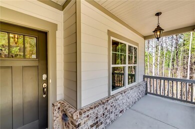 Entrance to property with a porch and stone siding