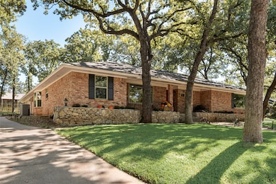 Single story home featuring a front yard and brick siding
