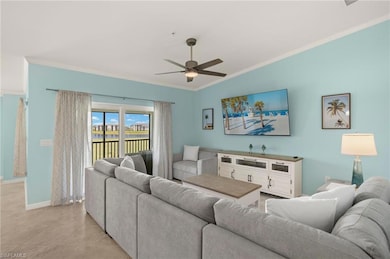Living room with crown molding, ceiling fan, baseboards, light tile patterned flooring, and vaulted ceiling