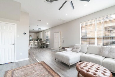Living room featuring ceiling fan, visible vents,