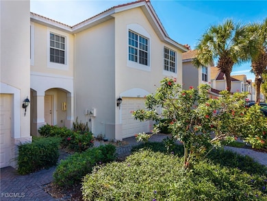 Tiled roof, stucco siding, and an attached garage