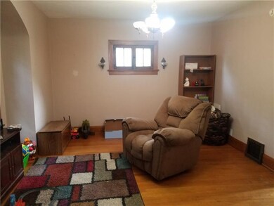Dining room used as a playroom. Hardwood flooring.
