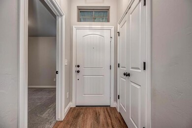 Entryway with dark wood-style floors and baseboards