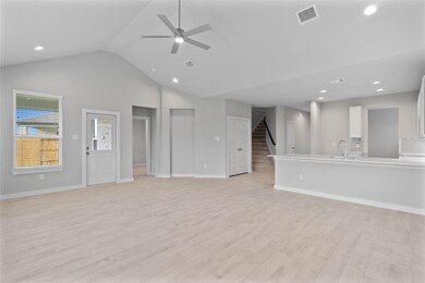 A beautiful view from the family room into kitchen and gorgeous staircase heading upstairs.