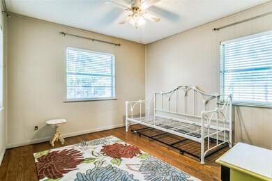 Bedroom featuring a textured ceiling, multiple win