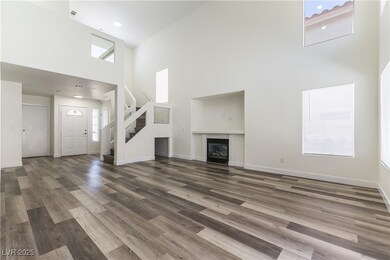 Unfurnished living room featuring a high ceiling,
