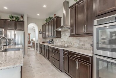Gourmet kitchen features built-in double ovens, st