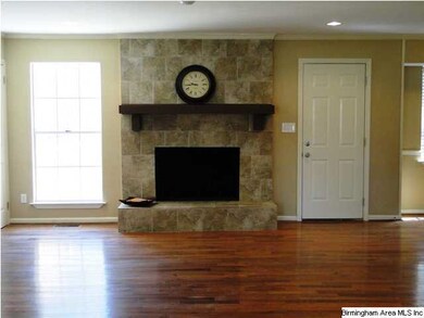 Tiled fireplace with hardwood floors