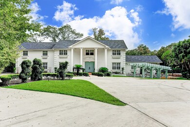 The front elevation of the home is the definition of timeless beauty with its white brick and two story pillars