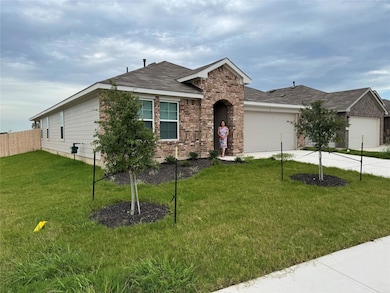 View of front of home with a garage, brick siding