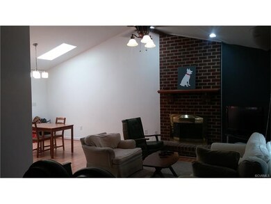 Wide open living space with brick fireplace, cathe