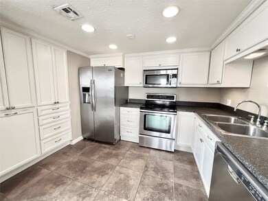 Kitchen w/ custom cabinets and SS appliances.