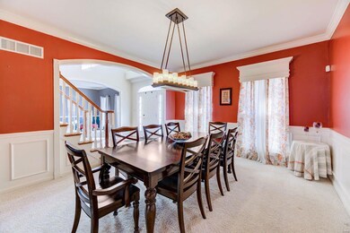 Formal dining room with arched entry and crown mol