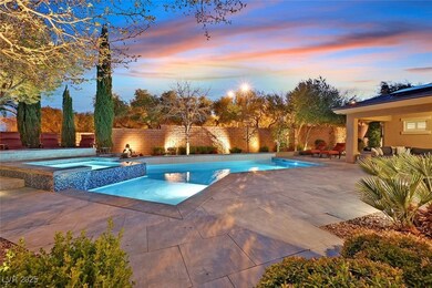 Pool at dusk with a raised spa and wet deck area /