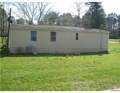 Exterior Back. Property has new 4-ton AC and new s