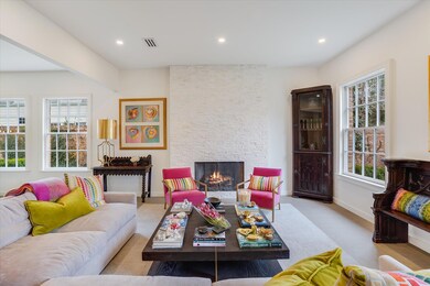 Living area with recessed lighting, visible vents