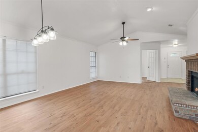 Unfurnished living room featuring a brick fireplac