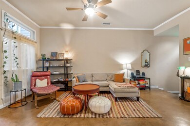 Crown moulding and ceiling fan in living area