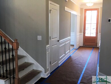 Gorgeous Foyer With Wainscoting and Crown