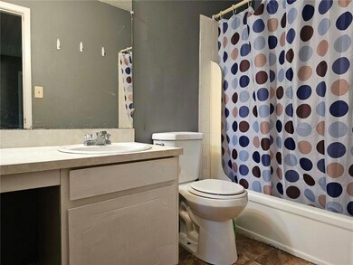Bathroom featuring vanity, toilet, and shower / tub combo with curtain
