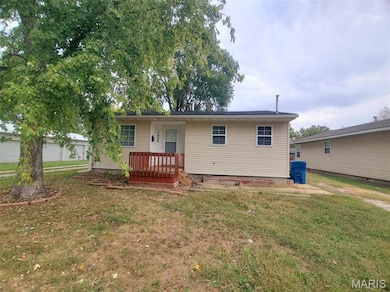 Ranch-style home featuring a front lawn