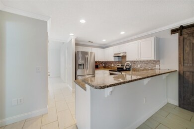 Follow the flow into the UPDATED KITCHEN that sits in the heart of this home with STAINLESS STEEL APPLIANCES, GRANITE COUNTERS, a closet pantry for plenty of storage and a BREAKFAST BAR for casual dining! 