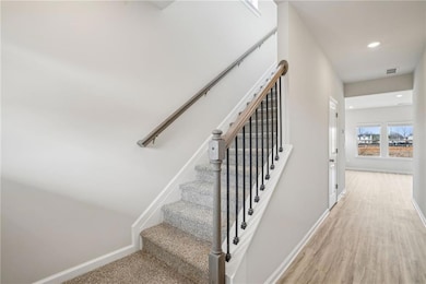 Stairway featuring wood-type flooring