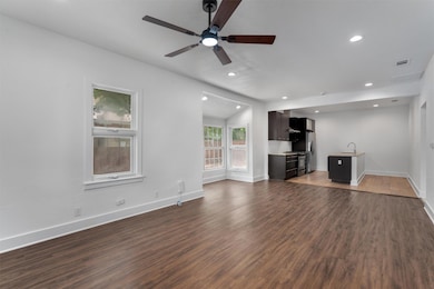 Unfurnished living room with a ceiling fan, wood 