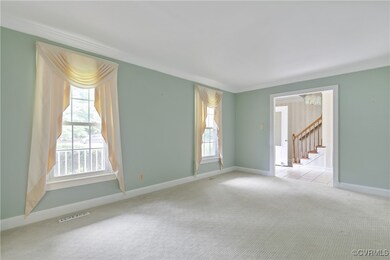 Living room with light carpet, ornamental molding,