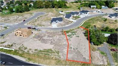 Aerial view of property's location with property parcel outlined and nearby suburban area