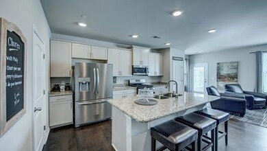 Lots of cabinets and island seating.  Granite and SS appliances.  All photos of another home.  Finishes will vary.