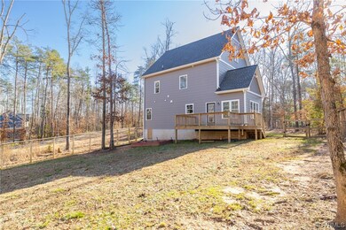 Rear view of property featuring a wooden deck