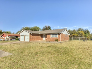 Single story home featuring driveway, brick siding, roof with shingles, and an attached garage