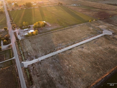 Aerial view of property and surrounding area with rural landscape and large plots for crops