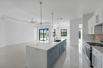 Kitchen featuring a kitchen island with sink, whit