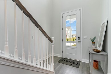 Entrance foyer with wood finished floors and stairs