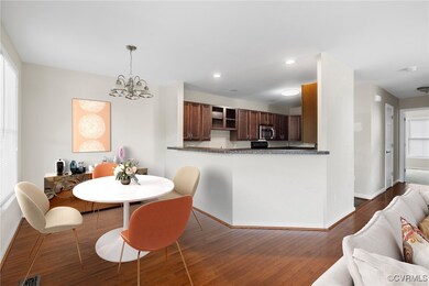 Dining space with hardwood / wood-style flooring and a chandelier