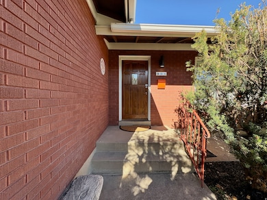 View of exterior entry featuring brick siding