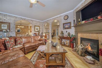 Another view of the cozy living room with fireplac