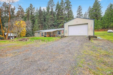 View of front of property featuring a garage, a front lawn, and driveway