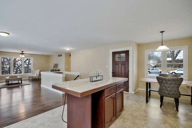 Kitchen opens to dining room and living room beyon